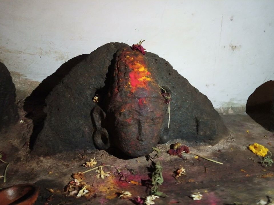 A Bodhisattva idol partly buried in the new concrete base inside the Kallesvara cave in Kalya, Magadi near Bangalore.